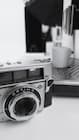 Cup of fresh coffee against a background of photographic equipment